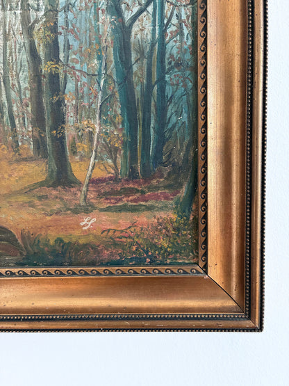 Framed painting of a forest scene with detailed gold frame