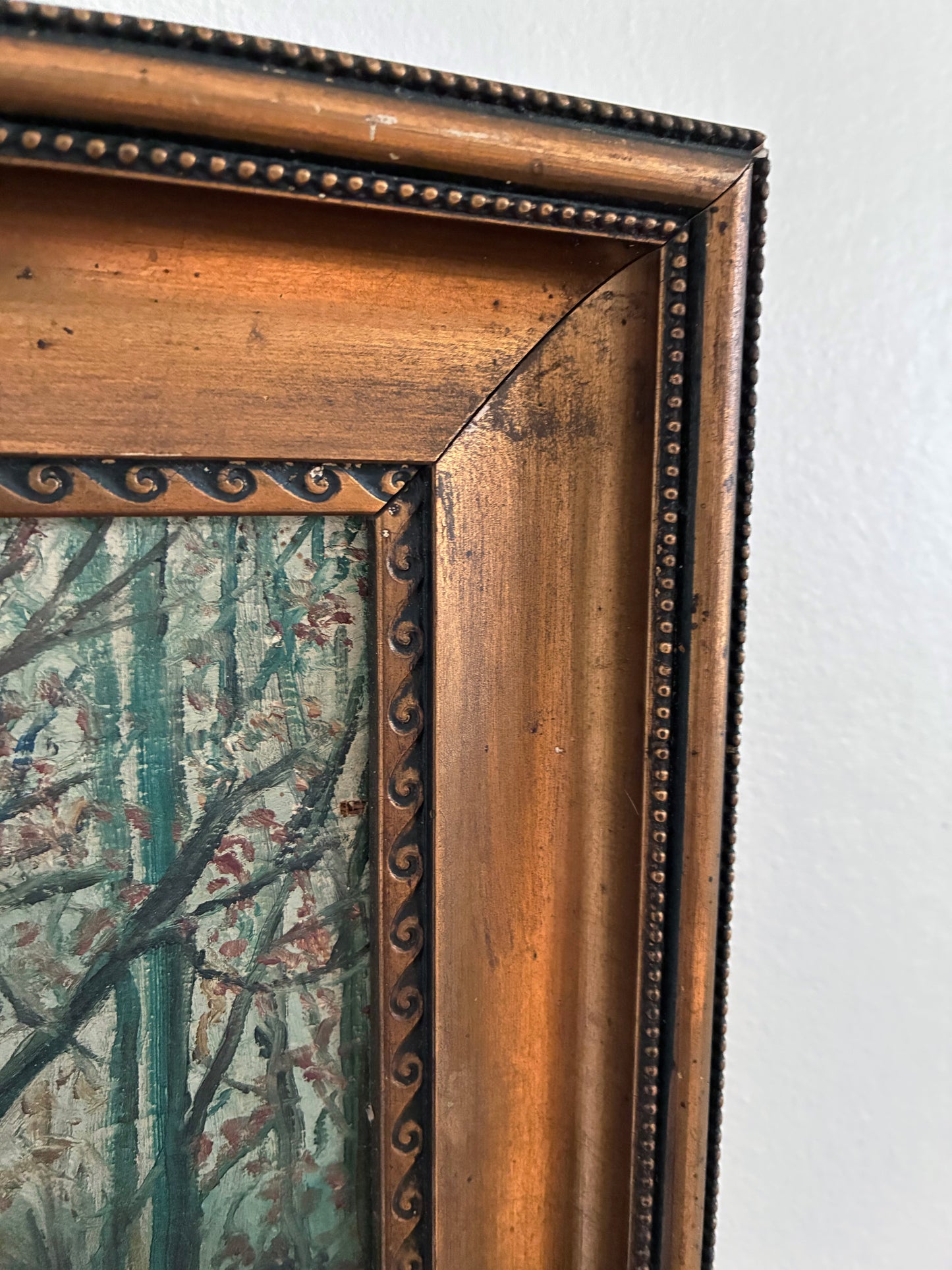 Close-up of an ornate wooden picture frame with a detailed design.