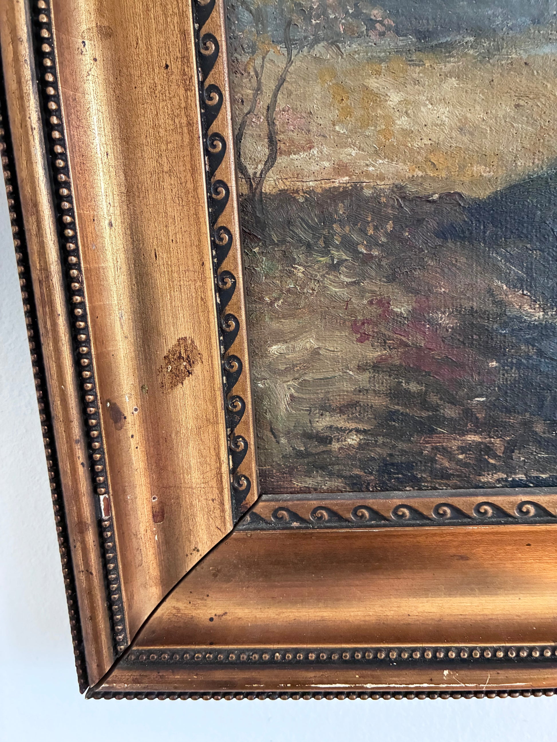 Close-up of a painting with a decorative gold frame on a white background