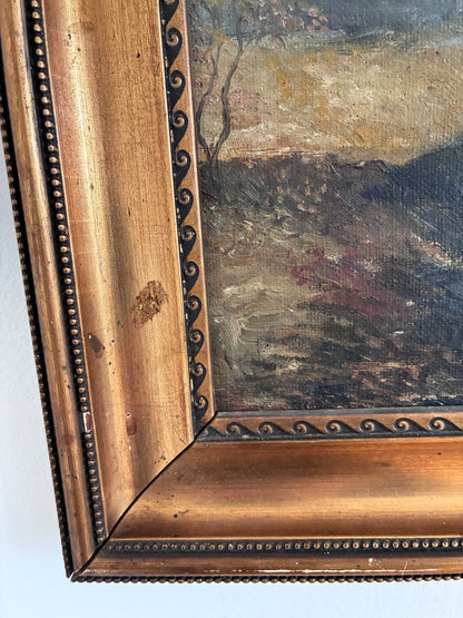 Close-up of a painting with a decorative gold frame on a white background