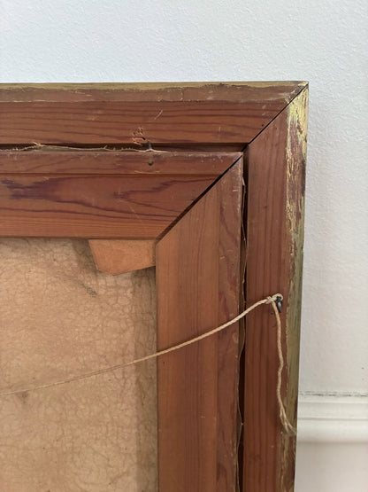 Close-up of a wooden picture frame with a visible crack.